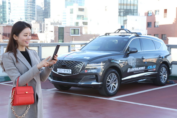 LG유플러스 모델이 서울시 상암 5G 자율주행 시범지구의 한 주차장에서 모바일 앱을 통해 5G 자율주행차 ‘A1’의 주차를 완료한 모습. 사진=LG유플러스