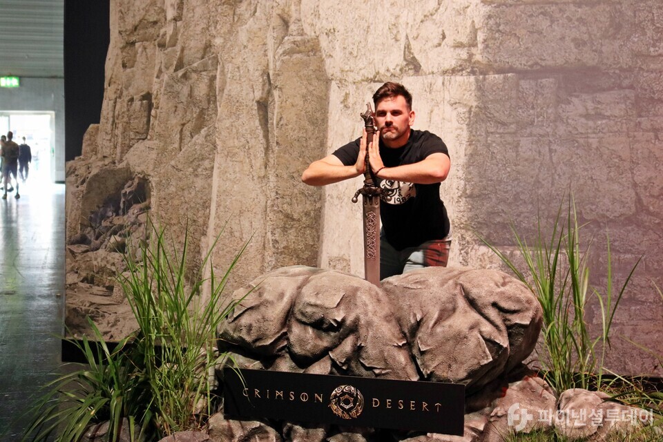 한 외국인 관람객이 22일(현지 시간) ‘게임스컴 2024’ 붉은사막 부스 앞에서 포즈를 취하고 있다. 사진=채승혁 기자