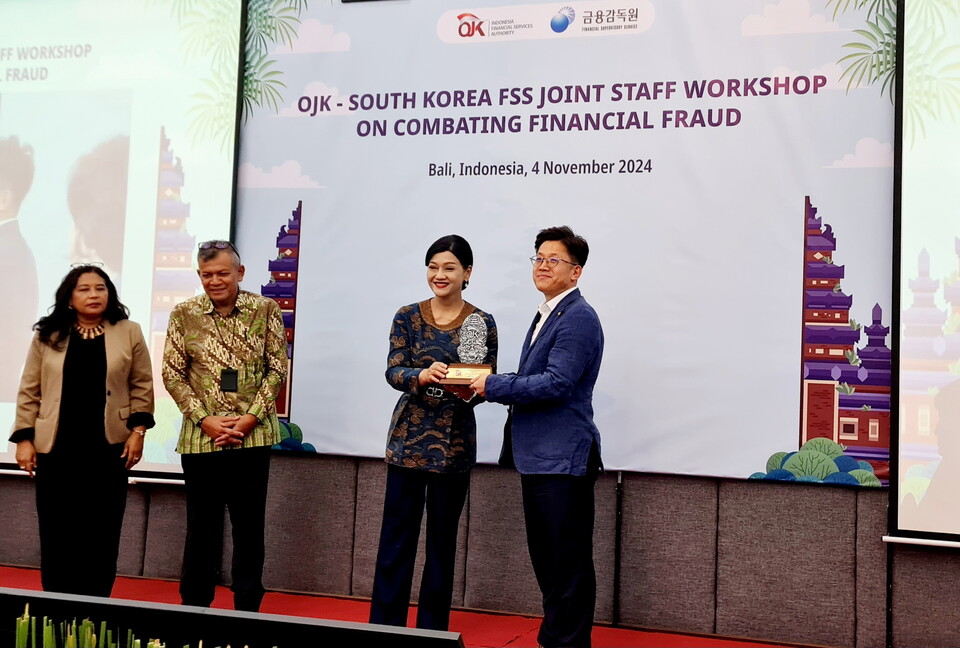 장종명 한화생명 융자Digital사업부 팀장(오른쪽)이 프리데리카 위디야사리 데위 인도네시아 금융감독청 소비자보호 담당 최고 책임자(오른쪽에서 두번째)에게 감사패를 받은 후 기념 촬영을 하고 있다. 사진=한화생명